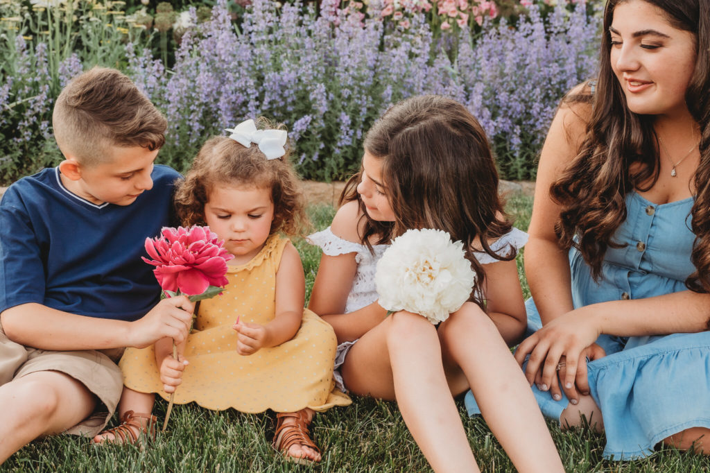 Family sitting in garden with flowers