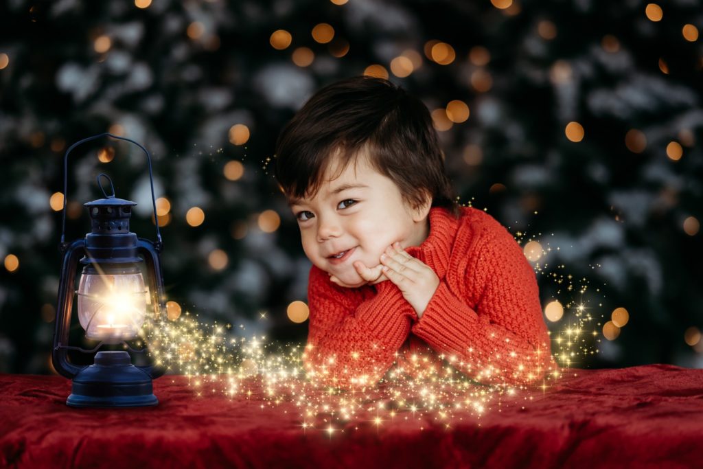 Little boy smiling in red Christmas sweater