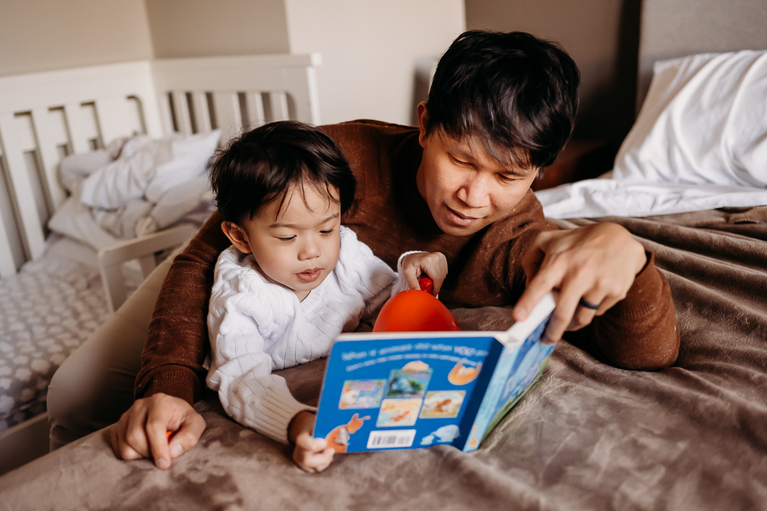father reading boy a bed time story